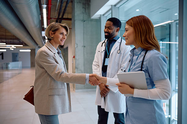 Healthcare administrator shaking hands with clinical staff, representing trusted partnership and workforce stability